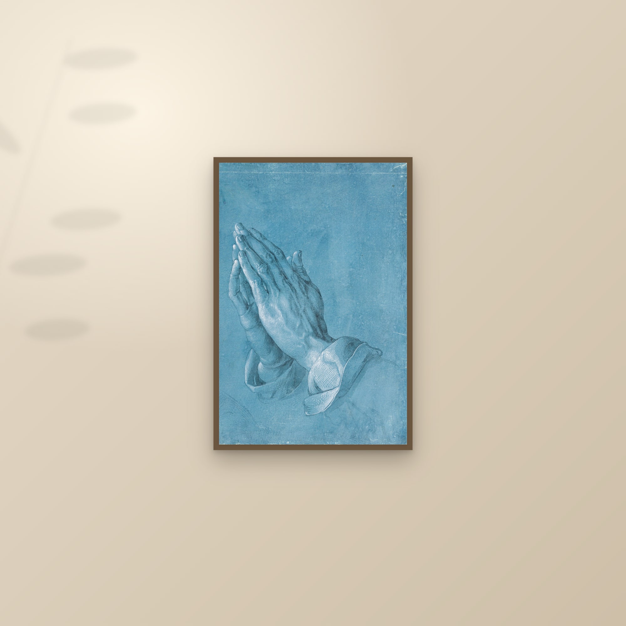 Praying Hands (Full) — Full-Bleed Edition — framed and styled on a sunlit wall