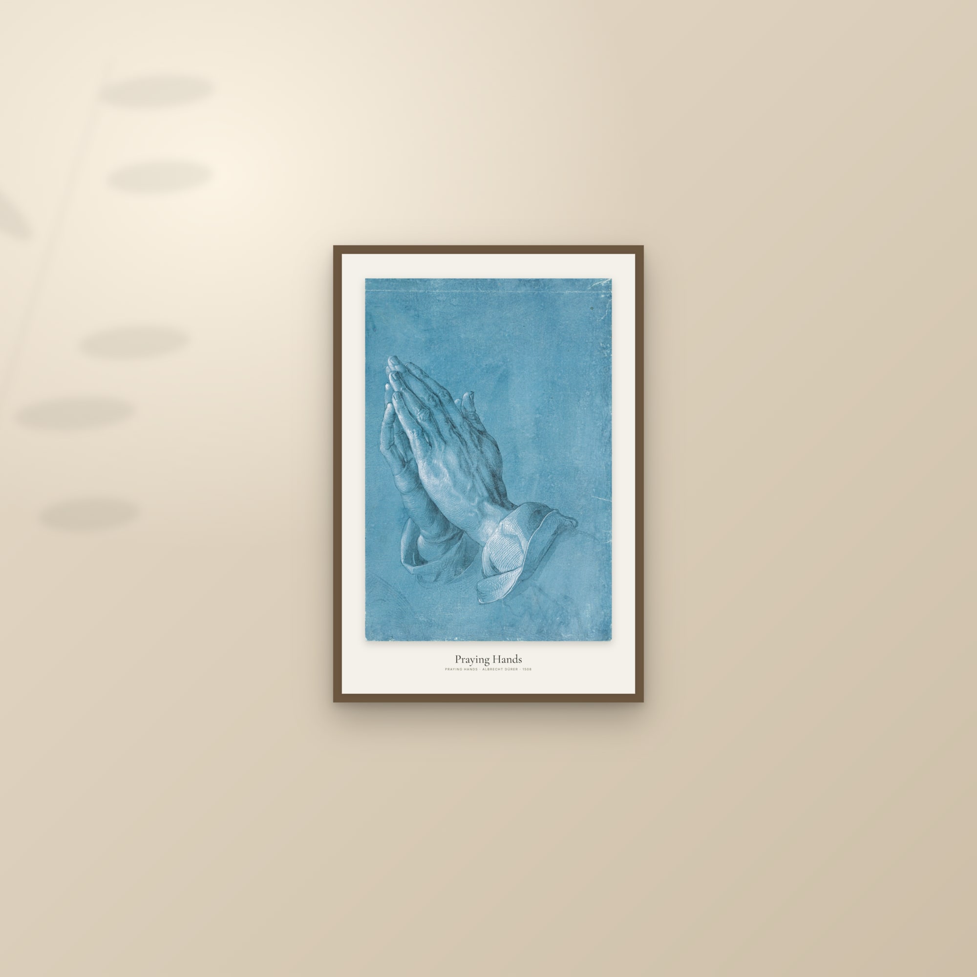 Praying Hands — framed and styled on a sunlit wall